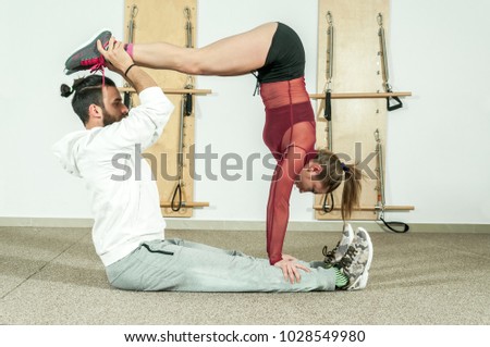 Young beautiful fitness couple workout extreme acrobatic exercise as preparation for the competition, selective focus