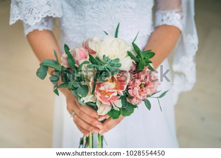 wedding white and pink bouquet in bride's hands 