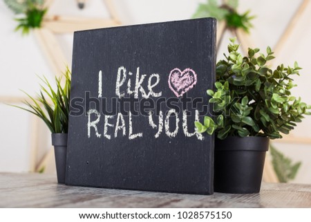 Black board with motivational inscription on the table. I like real you. Love motivation text.