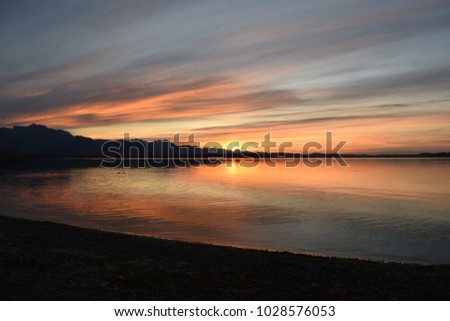 Sunset at Chiemsee, with some beautyful colours. Would make a nice backround for shoure. Royalty-Free Stock Photo #1028576053