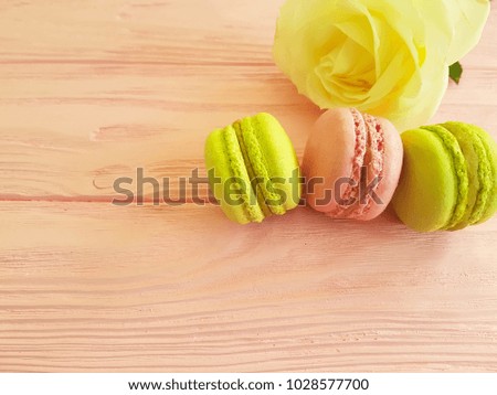 macaroon on a pink wooden, rose flower