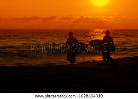 Surfers at sunset in Costa Rica