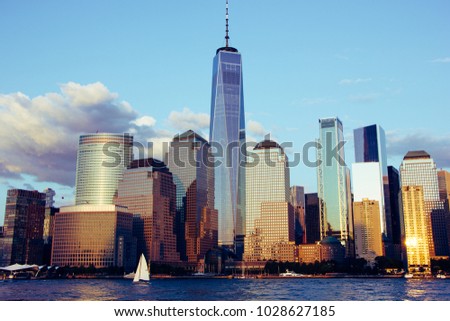 Skyline of New York City - in fron of it driving boats in the Hudson River