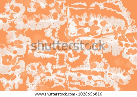 Orange wet abstract paint leaks and splashes texture on white watercolor paper background. Natural organic shapes and design.