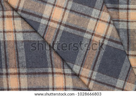 Flannel, cotton into the classic scottish cell as textile background in vintage style 
