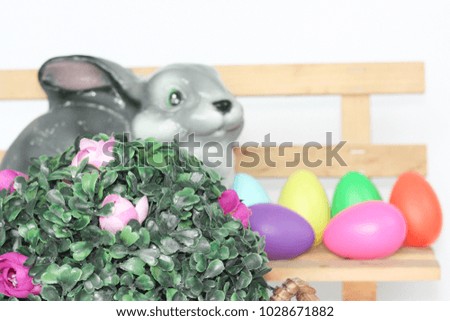 Easter. Easter bunny on a bench among eggs