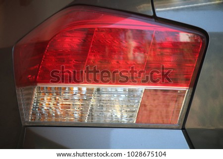 Red and white tail light Of gray cars