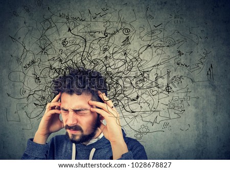 Thoughtful stressed young man with a mess in his head Royalty-Free Stock Photo #1028678827