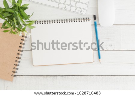 Empty open notebook on white wood table top view,Flat lay photo of office desk with mouse and keyboard
