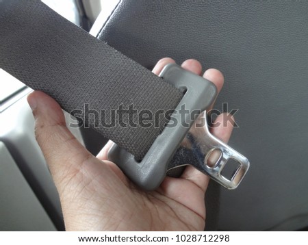 
Hand Holding Safety Seat Belt in The Car, A Vehicle Safety Device Use For Secure The Car Accidents and Occupant Ejection.  Royalty-Free Stock Photo #1028712298