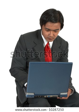 man sitting while working on his laptop computer