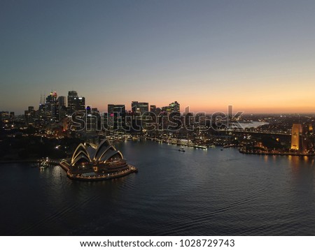 Aerial view of generic cityscape skyline at night, bird eye view of Sydney city architecture in Australia with opera house