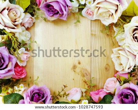 frame of flower bodrder top view on wooden background