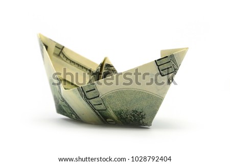 origami boat built of one hundred dollar bill