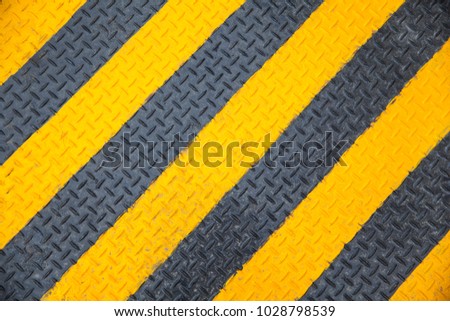 black & yellow diagonal metal plate background.