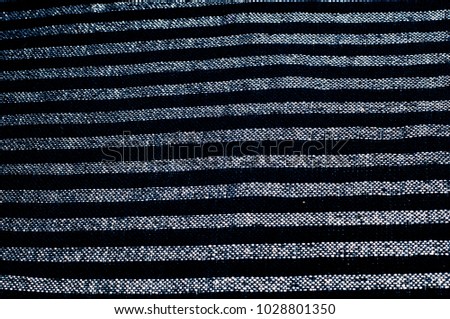 Texture, background, pattern. A woman's headscarf is dark blue. Square pattern of white metal fabric