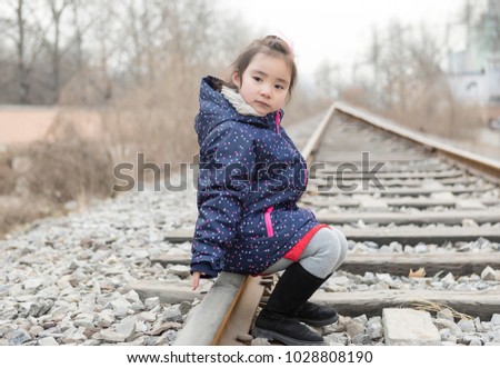 A lovely asian girl on the rails