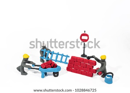 Abstract photo of buildings works. Figures made from Play Clay. Isolated on white background.