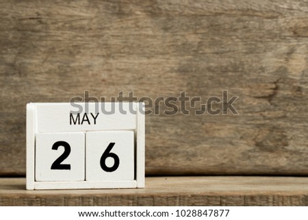 White block calendar present date 26 and month May on wood background