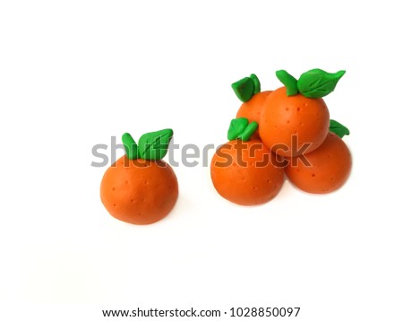 Delicious oranges made from plasticine clay arranged overlap, there is one piece dough separated from the group are placed on white background, Compared to people who have different ideas than others.