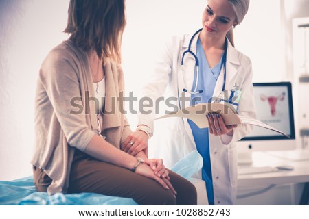 Doctor and patient discussing something while sitting at the table . Medicine and health care concept. Doctor and patient Royalty-Free Stock Photo #1028852743