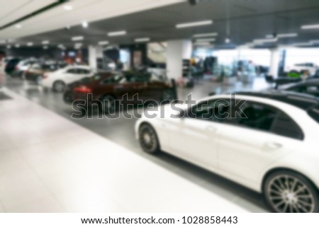 Blurred car dealership store bokeh background, Cars soft lightning, Blur bokeh transportation concept dealer showroom background. Blurry