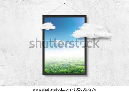 Picture frame with nature and clouds over white concrete wall background