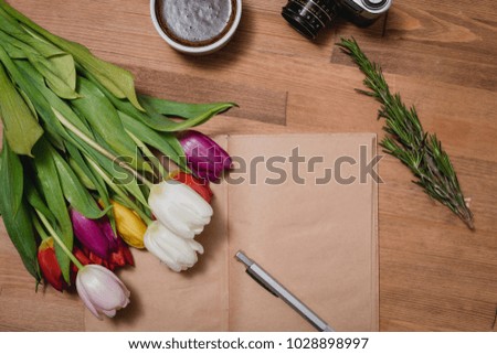tulips notepad camera wooden table
