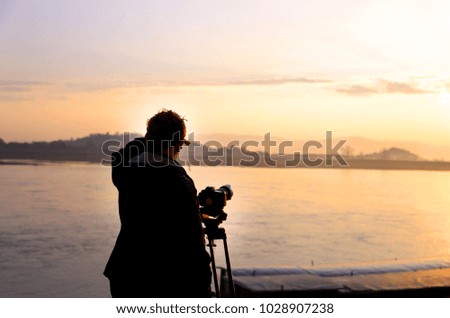 A photographer man at the riverside