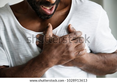 Black man having a heart attack Royalty-Free Stock Photo #1028913613