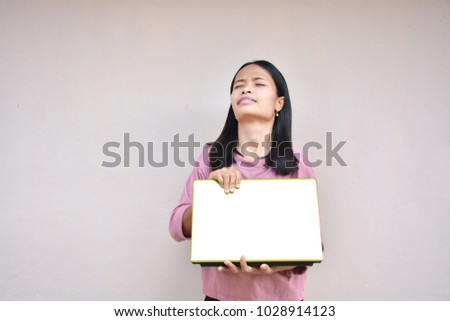 Asian woman playing in games on computer. Girl sits in domestic room interior