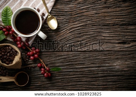 Top view mockup a cup of coffee and coffee beans in the sack on the wooden desk. Free space for your text.