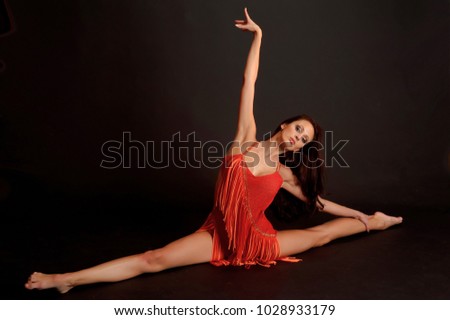 Beautiful brunette gymnast in red.