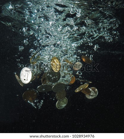 Coins of Russian rubles are drowning in the water