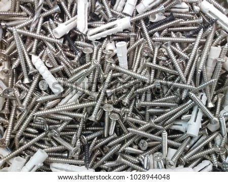 closeup group of screws and plastic plug anchor
