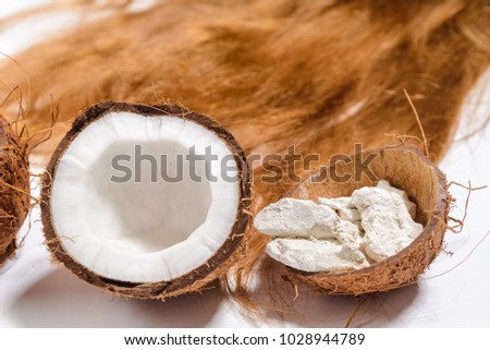 Beautiful hair a light natural make-up and perfect color. Picture taken in the studio on a white background.Natural ingredients coffee beans, clay, coconut. top view.