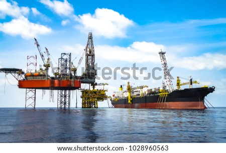 Jack up drilling rig on production platform with FPSO on site Royalty-Free Stock Photo #1028960563