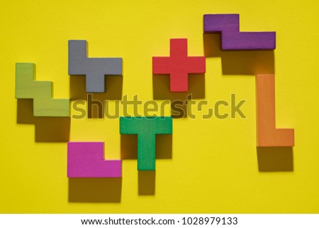 Abstract geometric background, colorful logic game. Isometric game blocks on yellow background. Pop art style design. Logical concept. 