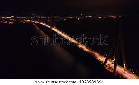Aerial bird's eye drone night shot of state of the art suspension bridge crossing Corinth Gulf, Greece