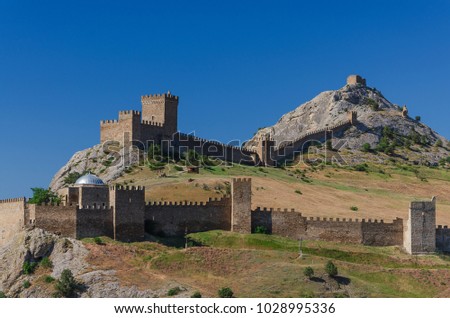 Beautiful Genoese fortress built on rocks above sea in Sudak city of Crimea. Royalty-Free Stock Photo #1028995336