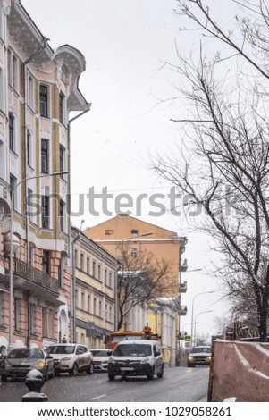 Houses built in the 19th century, in the center of the city during a snowfall. A good photo for the site about the seasons, weather, travel.