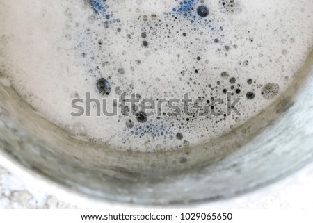 A texture of detergent bubbles in a bowl 