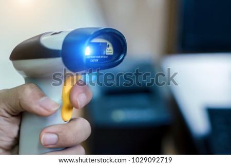 Carchie holding barcode scanner at counter service in the supermarket.This is for helping to save the sales information and print the receipt with the tax invoice.Modern technology