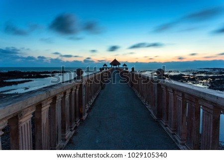 A Long exposure picture of stone jetty with blue hour background