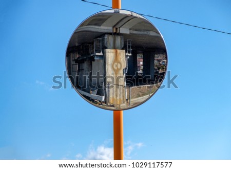 Glass reflection rounded signal traffic on blue sky at crossroad