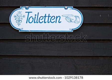 Toilet sign on wooden wall