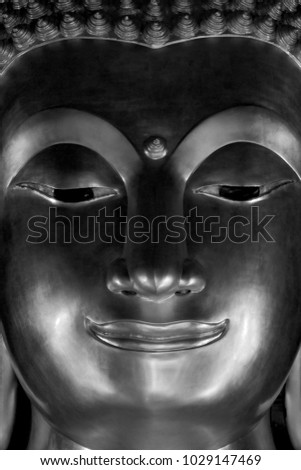 Close up picture of Buddha statue in Buddhist temple. Picture in black and white tone.