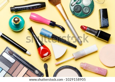 Photo on top of different cosmetics on yellow background
