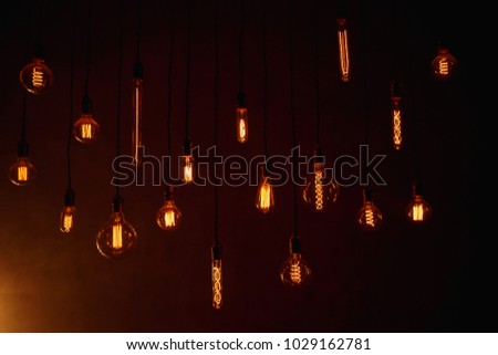 Retro edison lamp on a dark background, interior and lighting of modern photo studio, home. Loft style