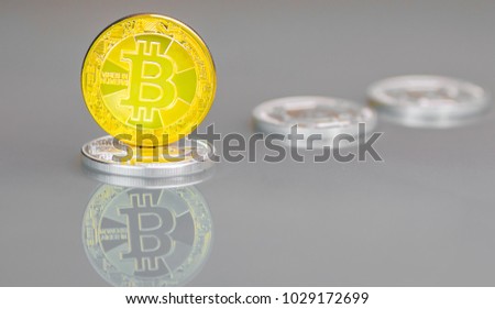 Modern digital gold crypto currency Bitcoin stands on silver Lightcoin